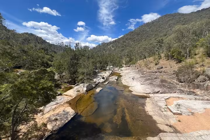 Breathtaking aerial view of rocky riverbed and vibrant forest during Blue Mountains private hiking tour.