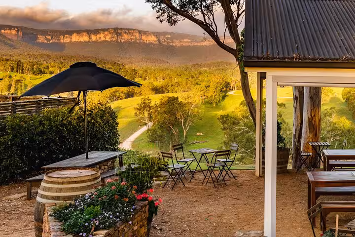 Outdoor seating area with stunning views of Blue Mountains, ideal spot for relaxation on a private hiking tour.