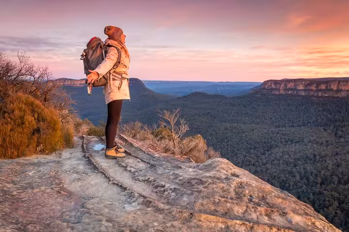 Traveler enjoying breathtaking sunset view over Blue Mountains during private daily group tour adventure.