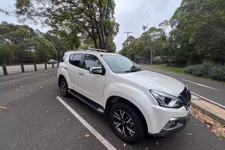 Comfortable white SUV parked in a serene location, ready for Blue Mountains winery tour pick-up and drop-off.