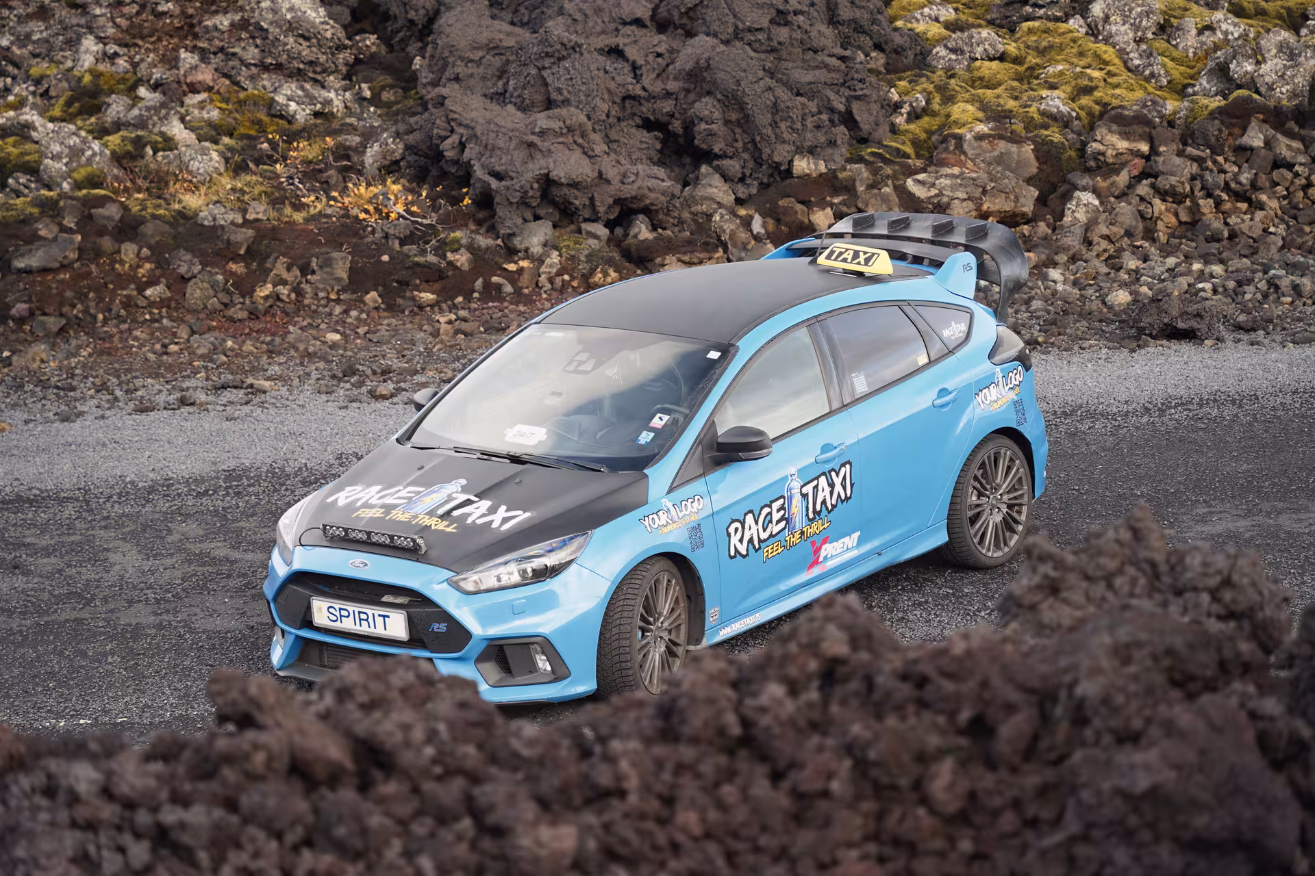Blue Race Taxi rally car on South Coast Adventure route through Iceland lava fields, high-speed sightseeing