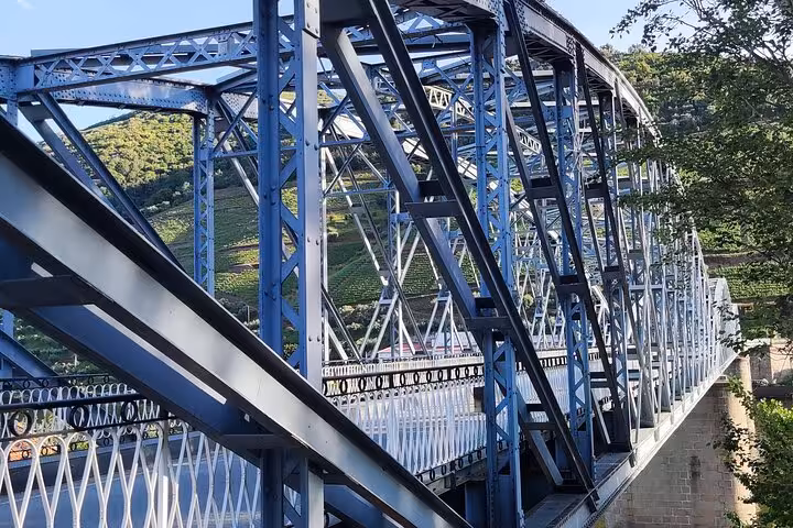 Blue steel bridge in Pinhão, Douro Valley, Portugal, a key stop on Visit Pinhão wine and river tours