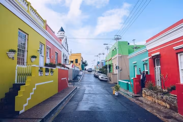 Colorful Bo-Kaap street with vibrant houses under a clear blue sky, showcasing Cape Town's cultural heritage.