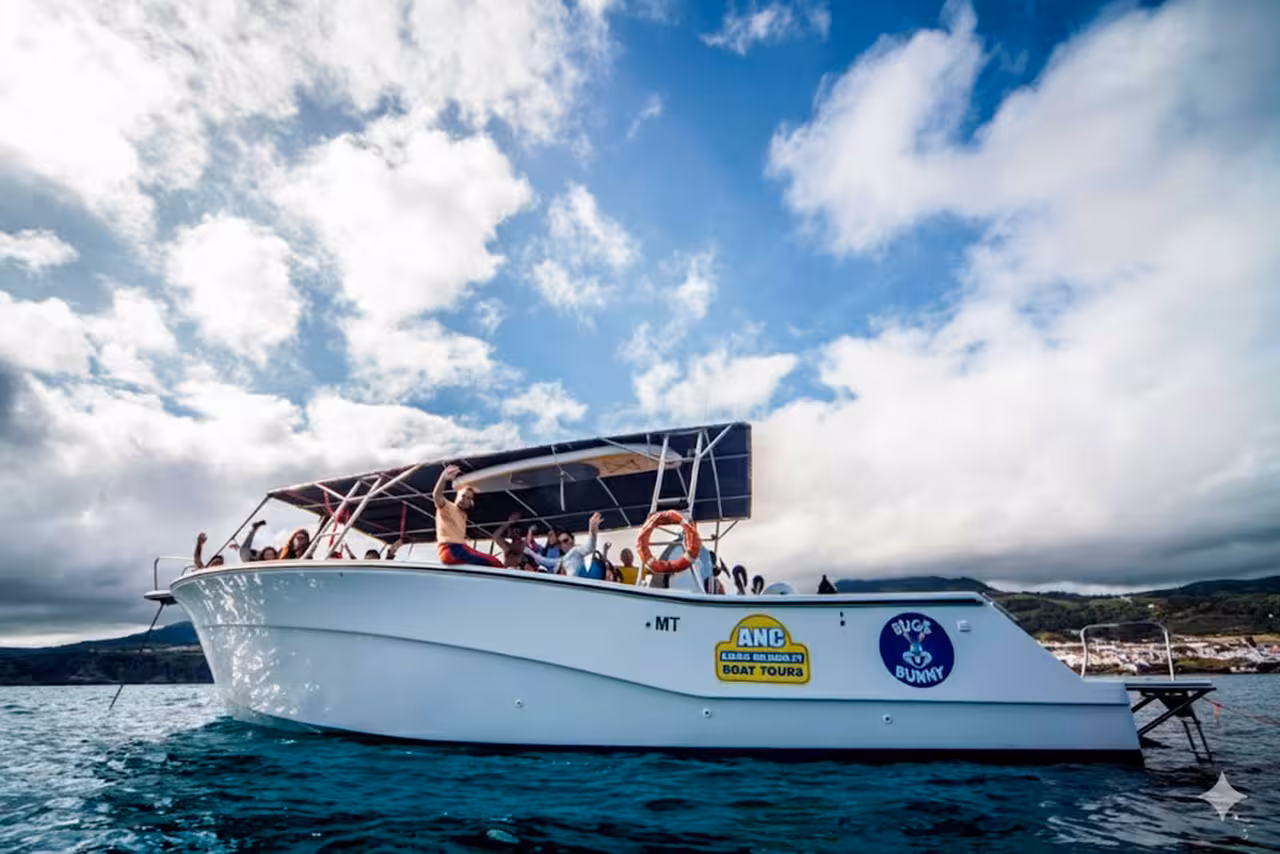 Group of friends wave from a spacious tour boat on a sunny half-day cruise, enjoying coastal views and fun activities at sea