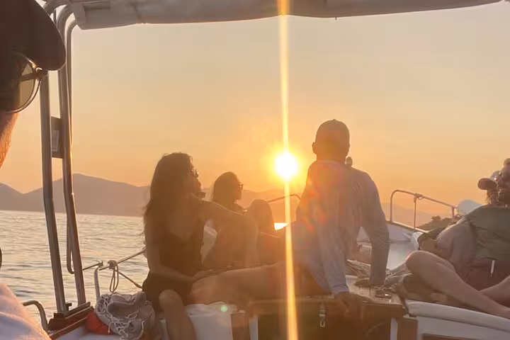 Tourists enjoy a stunning sunset on a boat tour from La Spezia to Portovenere, capturing a serene seascape moment.
