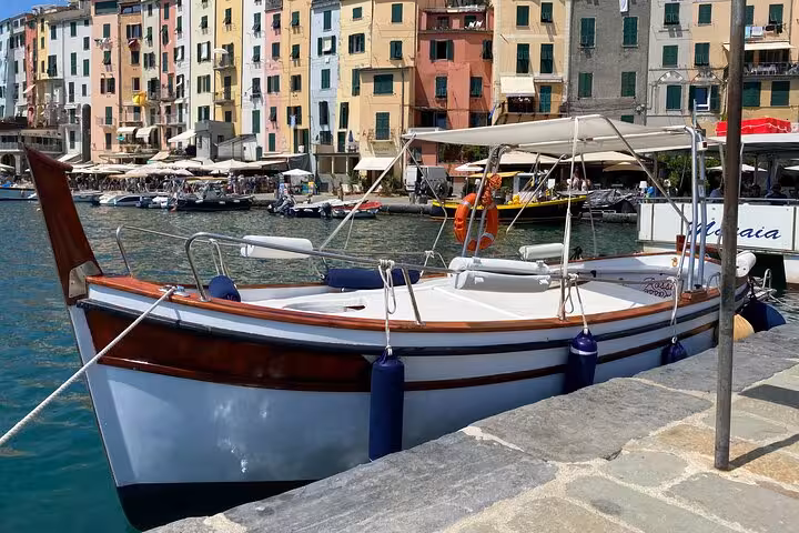 Docked traditional boat in vibrant Portovenere, ideal for La Spezia, Lerici, and Tellaro island tours.