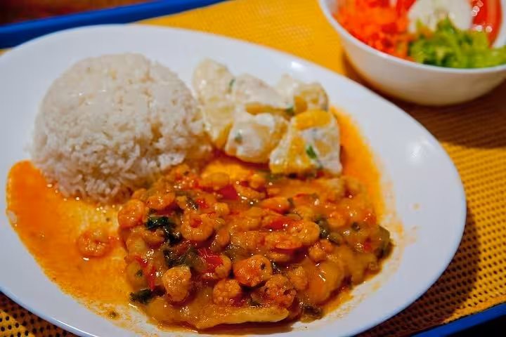 Delicious seafood meal with rice and salad on a boat tour by Paraty Tours, showcasing a taste of the sea.