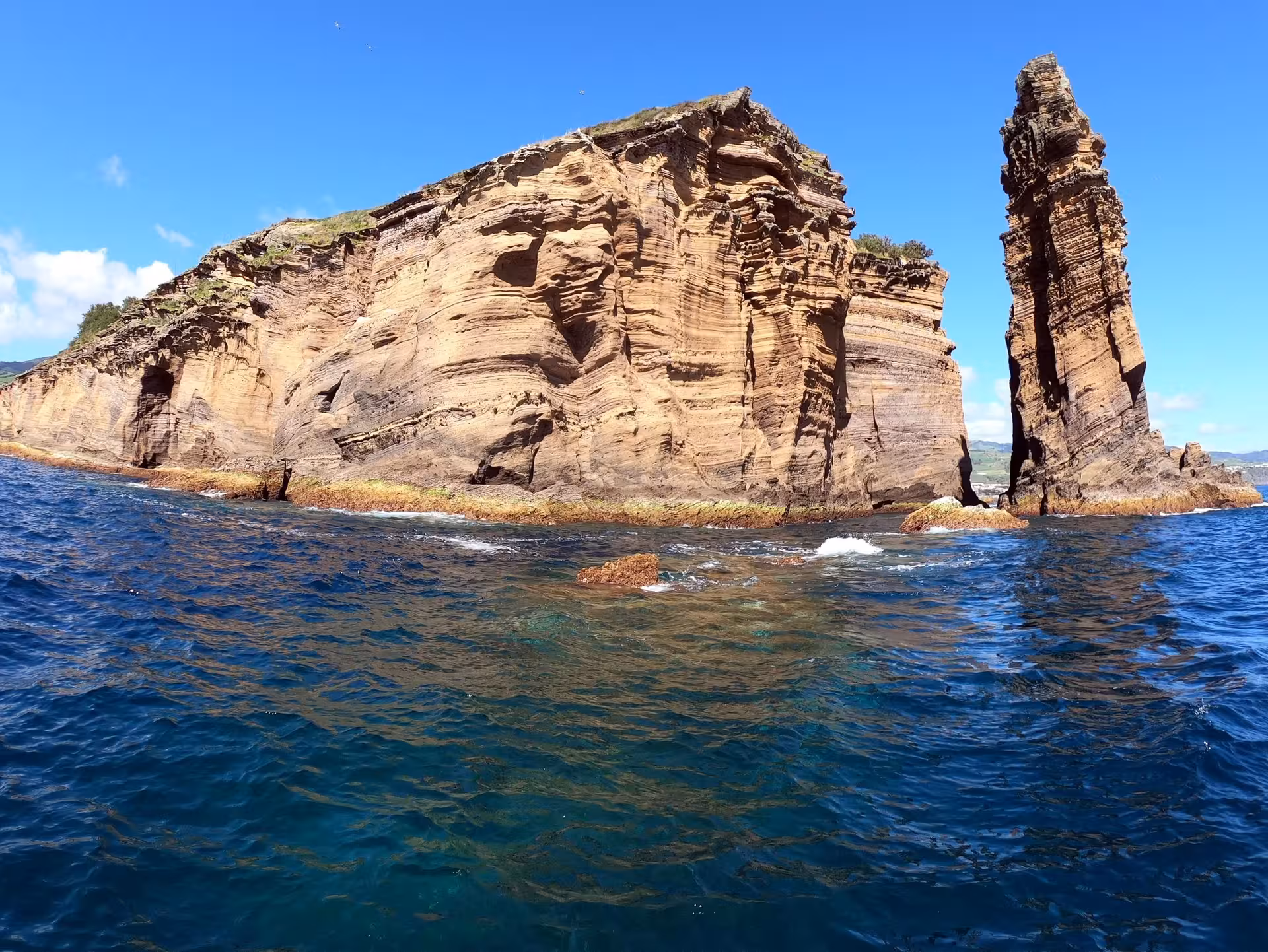 Boat tour view of Vila Franca do Campo Islet cliffs and sea stack, São Miguel Azores coastline