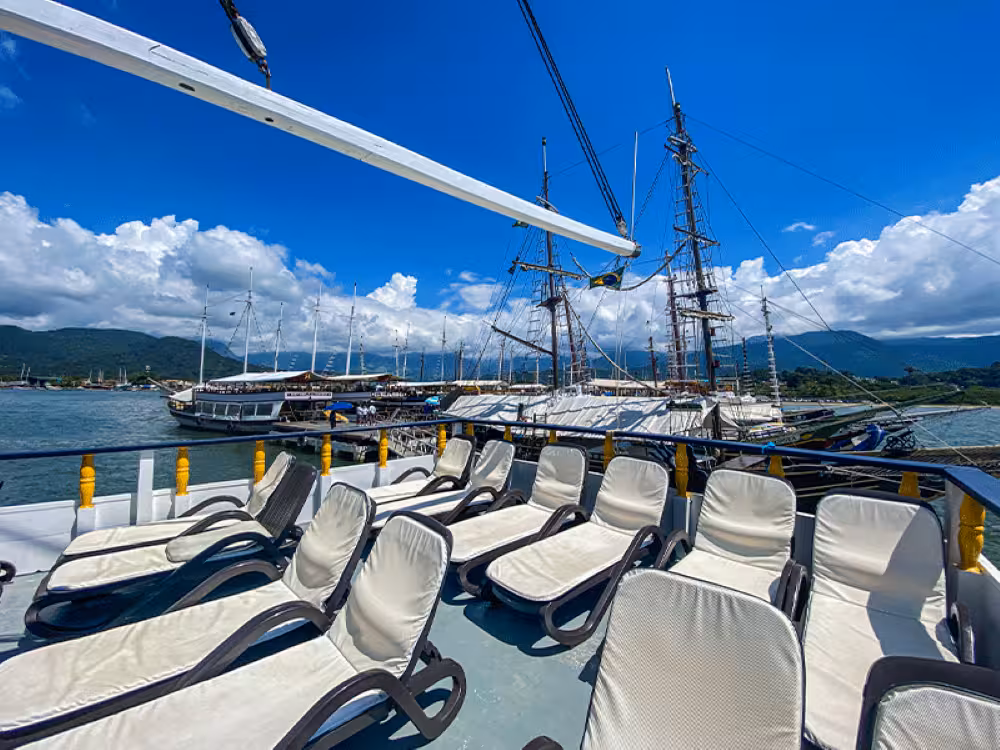 Spacious boat deck with sun loungers, perfect for a 5-hour scenic cruise with a complimentary caipirinha.