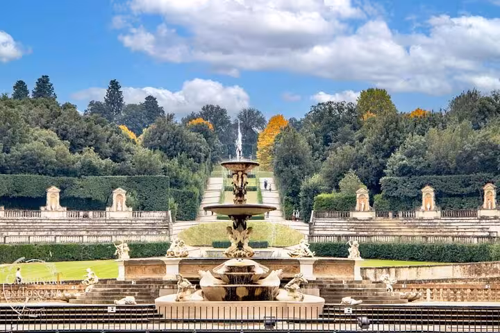 Explore the stunning Boboli Gardens in Florence, featuring a grand fountain surrounded by lush greenery and historic sculptures.