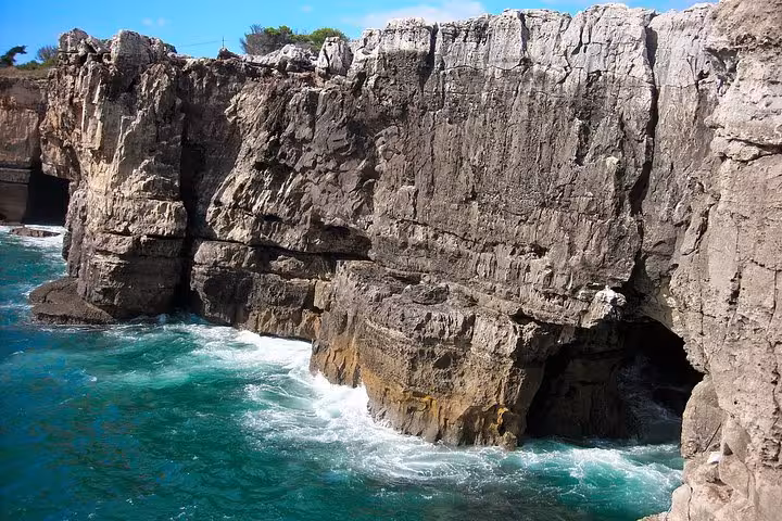 Dramatic rocky cliffs and turquoise waters at Boca do Inferno in Cascais.