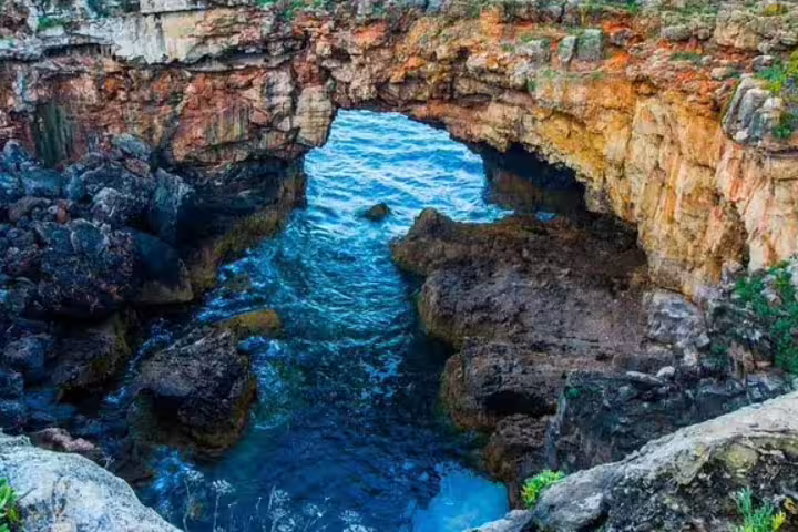 Scenic view of Boca do Inferno's rocky cliffs and ocean waves in Cascais, a highlight of the Private Sintra-Cascais Tour.