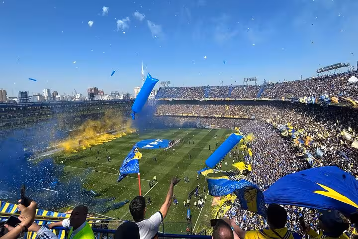Boca Juniors matchday crowd at La Bombonera with blue and yellow flags, guided tour with transport in Buenos Aires