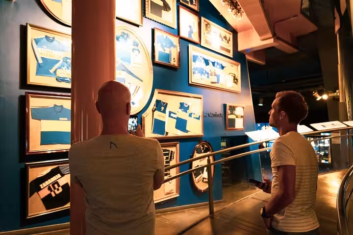 Visitors view framed Boca Juniors jerseys inside the museum on a La Boca guided tour in Buenos Aires