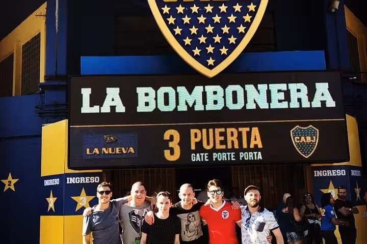 Group photo at La Bombonera entrance on a Boca Juniors Museum tour in La Boca, Buenos Aires