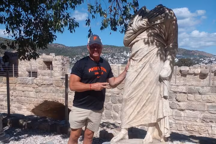 Cruise passenger with ancient statue at Bodrum Castle, guided Bodrum city tour shore excursion in small group