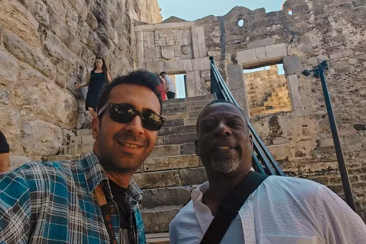 Guests exploring Bodrum Castle stone stairway on a small group Bodrum city tour with cruise port pickup