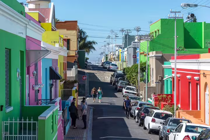 Vibrant Bo-Kaap neighborhood with colorful houses and pedestrians, a highlight on Cape Town's cultural tours.