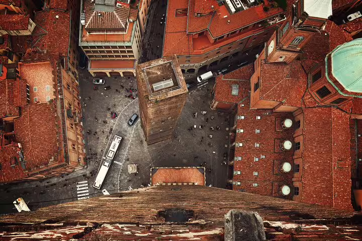 Aerial view from Bologna’s Asinelli Tower over Piazza di Porta Ravegnana and medieval streets on a guided walking tour