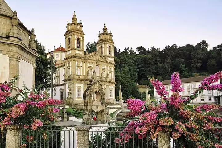 The stunning façade of Bom Jesus do Monte in Braga, adorned with vibrant flowers, captivates visitors on the private tour.