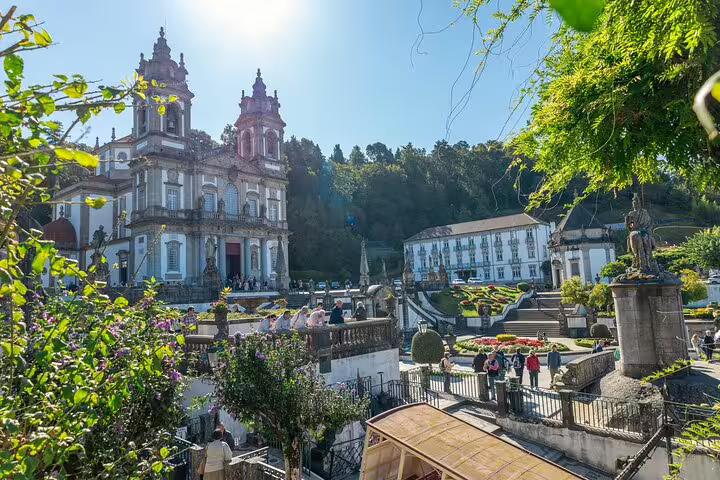 Bom Jesus do Monte sanctuary in Braga with ornate gardens and vibrant greenery under a clear sky.