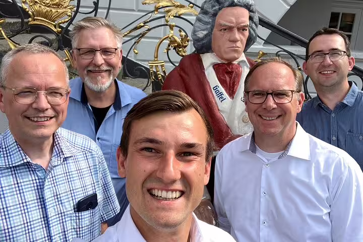 Group selfie by Beethoven statue in Bonn, perfect moment on a self-guided scavenger hunt and sights tour