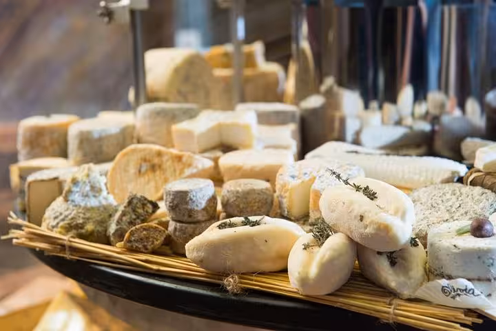 A diverse selection of artisanal cheeses on display during a Bordeaux food and wine walking tour.