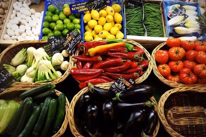 Colorful assortment of vegetables in baskets at a Bordeaux market, ideal for exploring local produce on a food tour.
