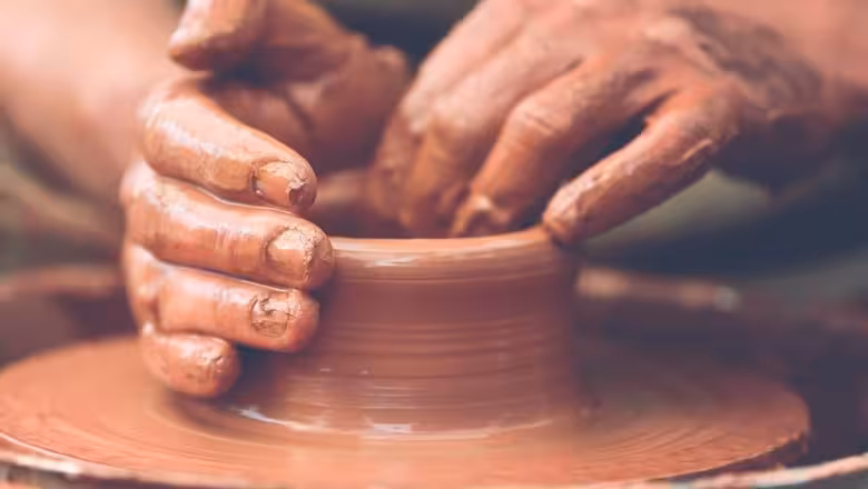 Hands shaping clay on pottery wheel, traditional craft stop on Borobudur VW Safari Tour village experience