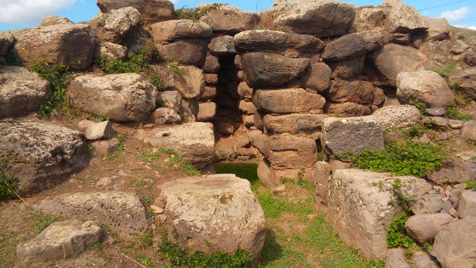 Explore ancient stone ruins surrounded by greenery on the Borore archaeological tour with tasting experience.