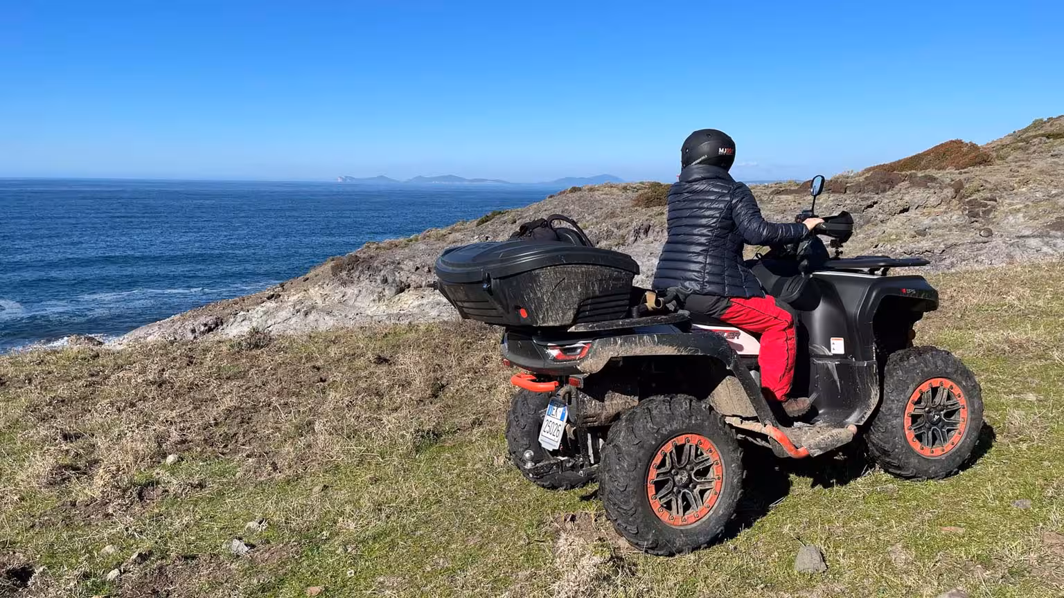 ATV rider enjoys scenic coastal view on Bosa's rugged terrain during a thrilling 3-hour tour.