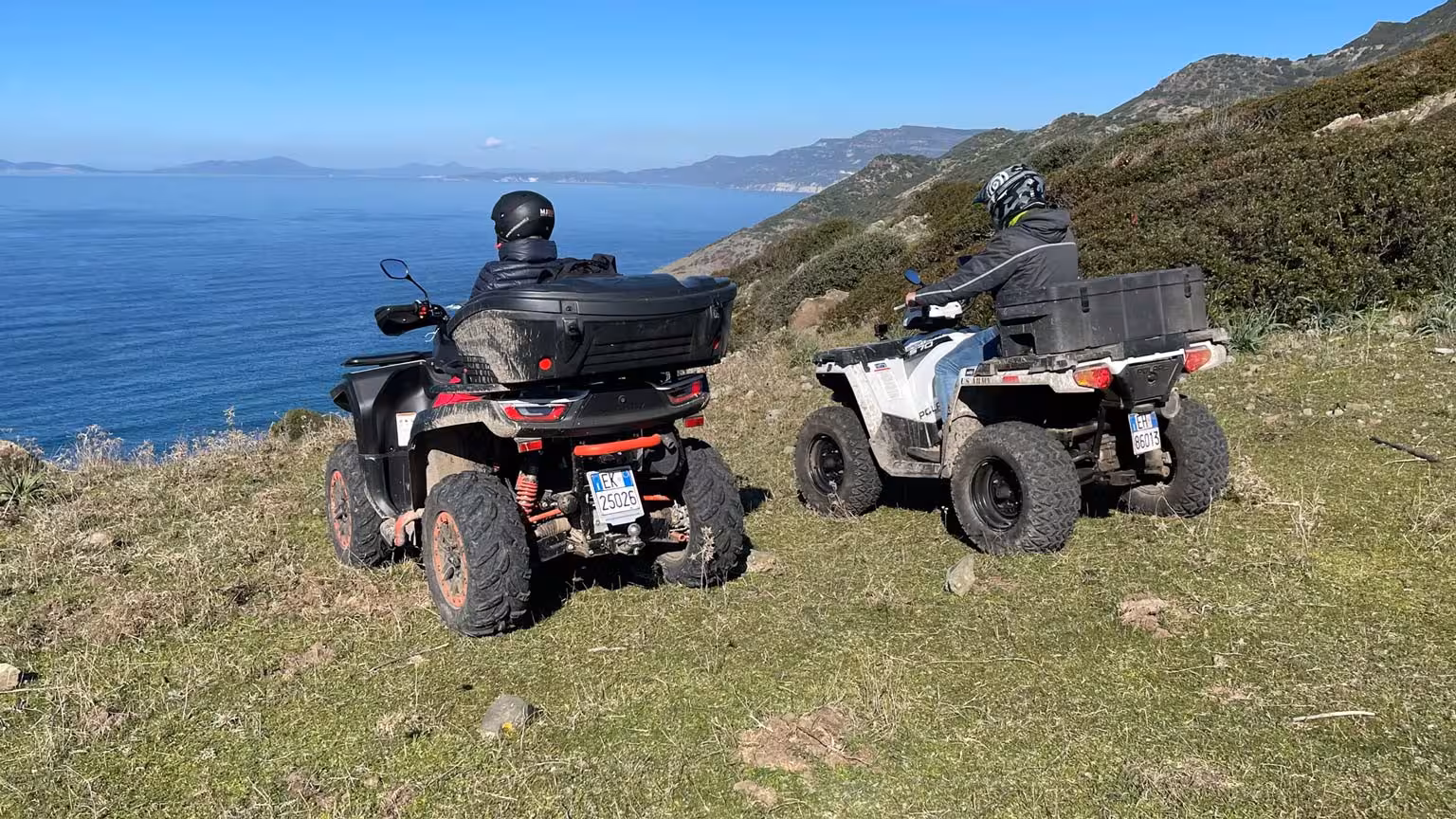 Two ATV riders pause to admire the stunning ocean panorama on Bosa's adventurous 3-hour off-road tour.