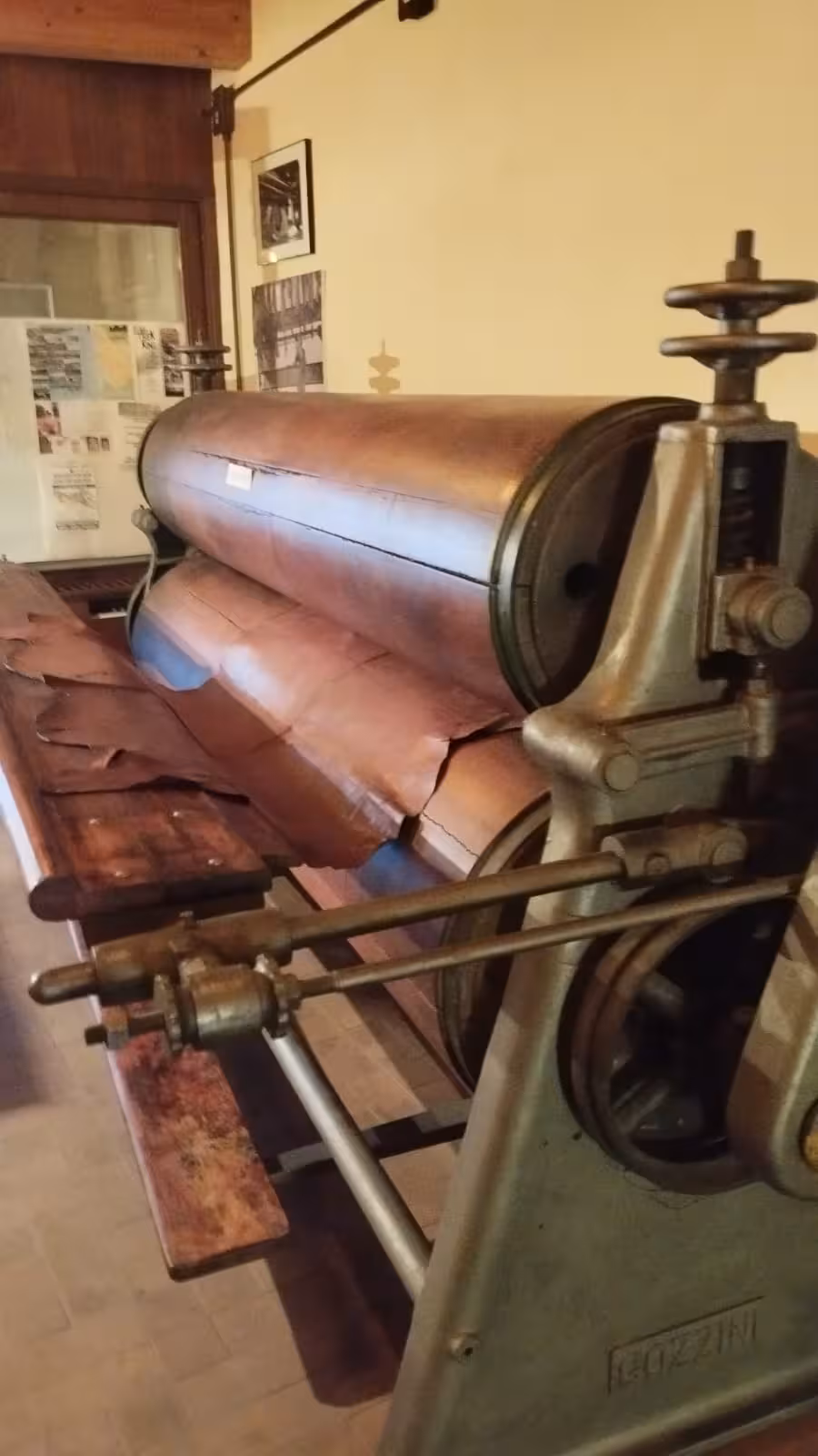 Historic leather pressing machine at Bosa's Tannery Museum, perfect for cultural immersion and wine tasting experience.
