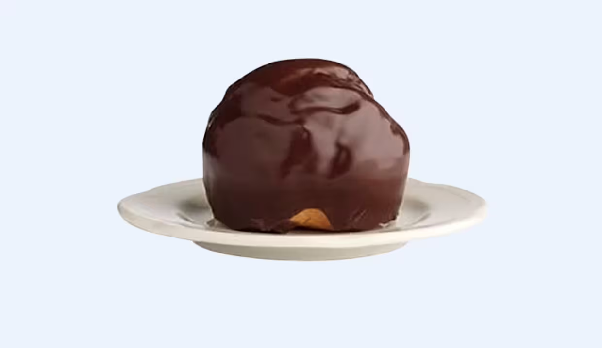Bossche bol chocolate pastry on a plate, must-try treat on a Den Bosch 1 day walking tour audioguide