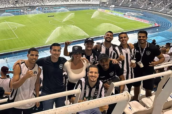Botafogo fans with local host at Nilton Santos Stadium, Rio, before match on Botafogo game tour