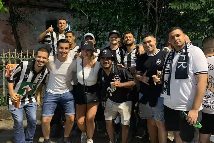Group of Botafogo supporters posing with local guide in Rio before match, Botafogo soccer experience