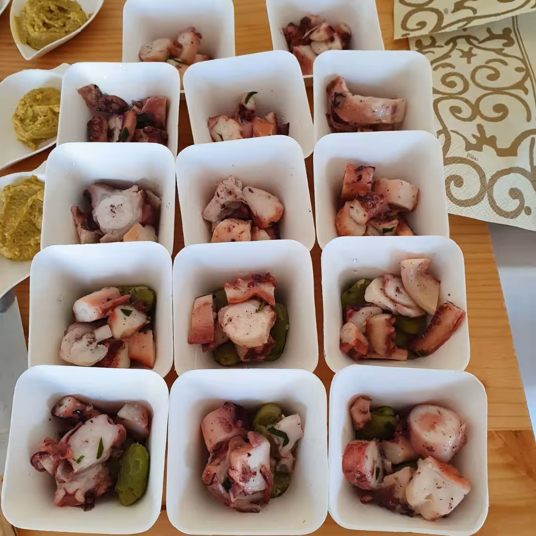 Savor local flavors with octopus and olive appetizers, a gourmet treat on the Boutique Winery Tour near Cagliari.