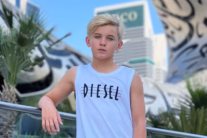 Young boy at Museum of the Future, capturing Dubai's iconic architecture on a layover tour.