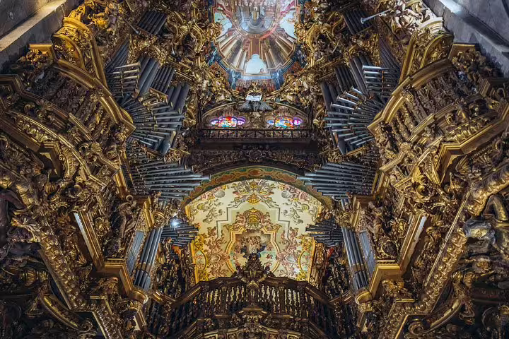 Intricate baroque interior of a church in Braga, featuring ornate gold details and a stunning ceiling design.