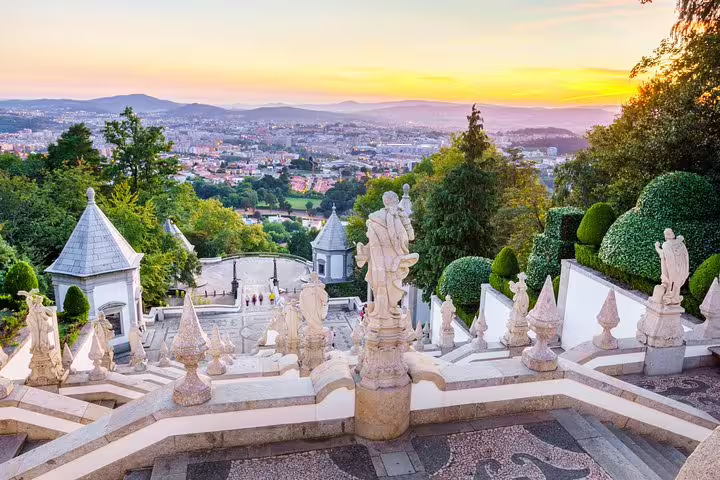 Scenic view from Bom Jesus do Monte showcasing stunning architecture and lush greenery at sunset in Braga.