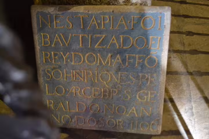 Historic inscription at Braga Cathedral, showcasing cultural heritage on the Braga and Guimarães tour from Porto.