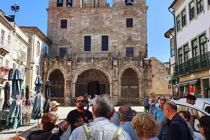 Tour group exploring the historic Braga Cathedral on a sunny day during a private half-day tour from Porto.