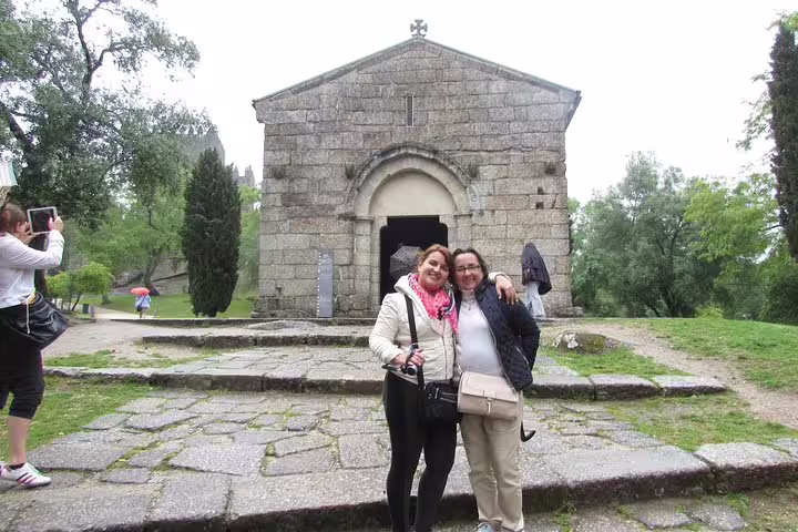Visitors enjoy a historic stone church in Braga during a scenic tour from Porto, showcasing Portugal's rich heritage.