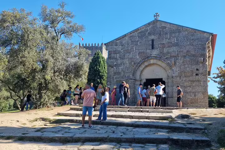 Tourists explore the medieval church in Guimarães, a highlight of the Braga and Guimarães private historic tour.