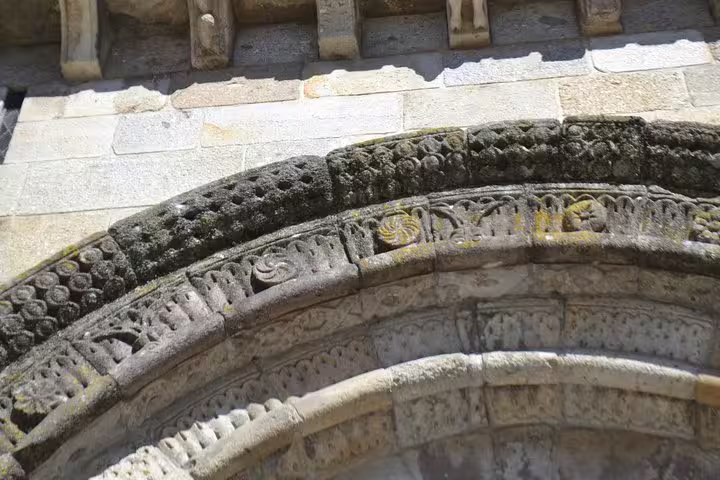 Intricate stone carvings on a historic archway in Guimarães, featured in the Braga and Guimarães tour from Porto.