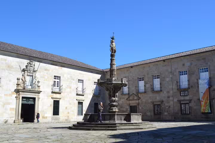 Historic courtyard with ornate fountain in Braga, showcasing architectural beauty on a sunny day during the Porto tour.