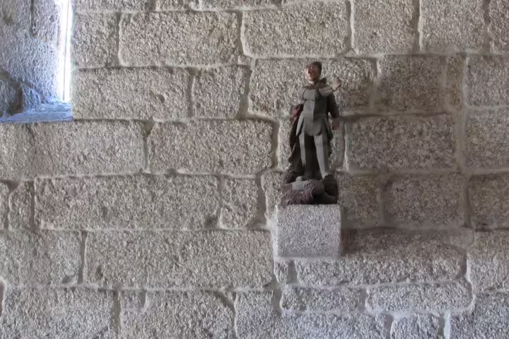 Intricate statue on a stone wall at a historic site in Braga, Portugal, featured in the half-day private tour from Porto.
