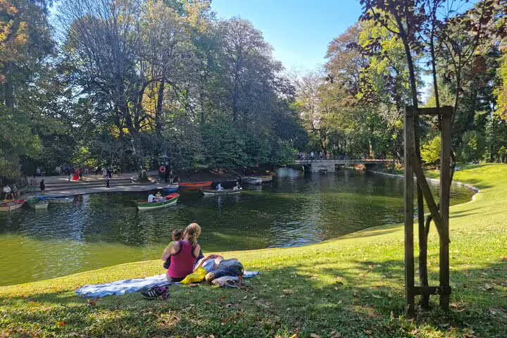 Visitors enjoy a peaceful afternoon by the lake in a scenic park in Braga during the Porto historic tour.