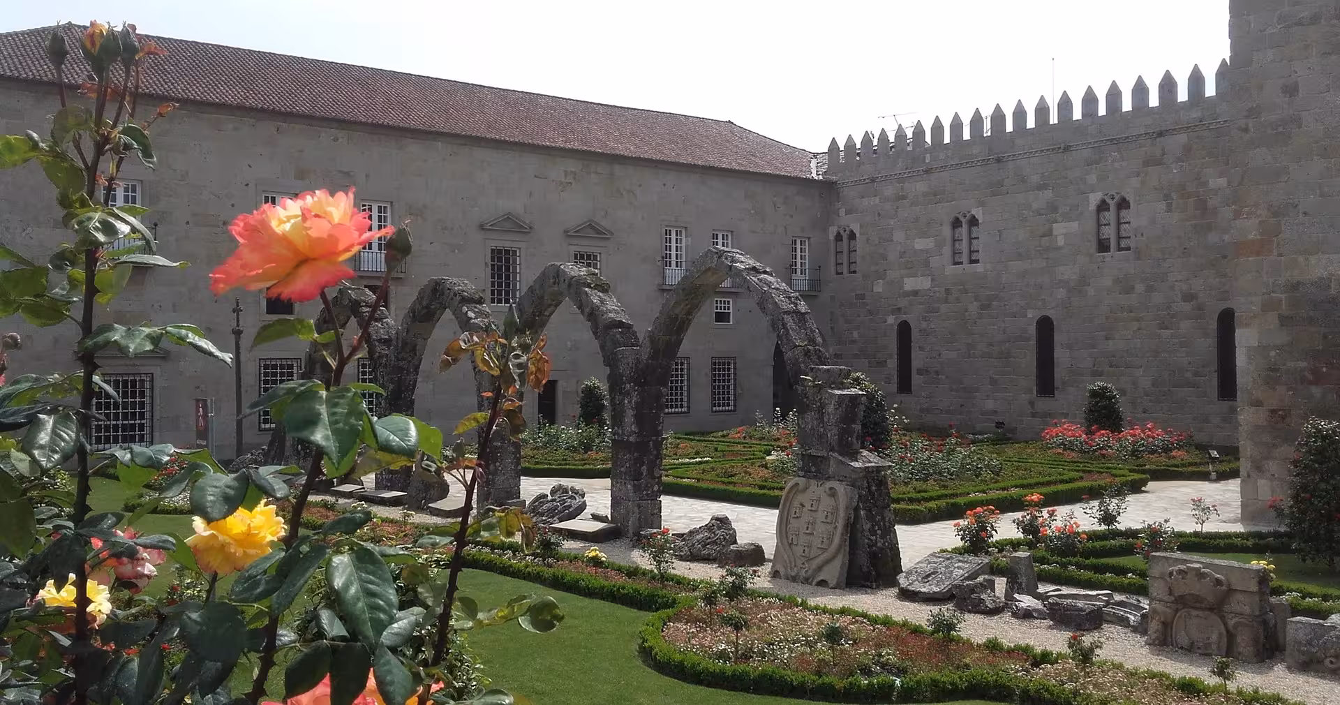 Braga small-group tour view of medieval stone arches and manicured gardens near Braga Cathedral, Portugal