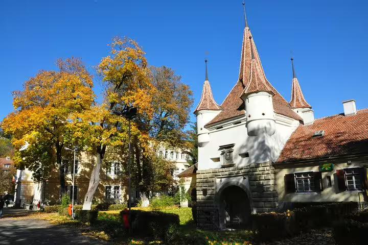 Catherine's Gate medieval fortified tower with autumn trees in Brasov Old Town, Romania